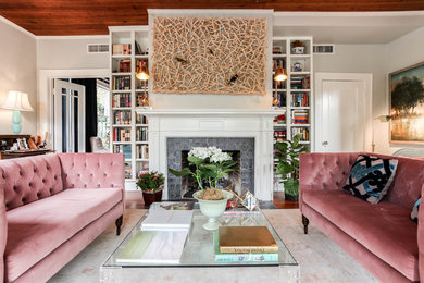 Transitional formal living room in Austin with grey walls, a standard fireplace and a wood fireplace surround.
