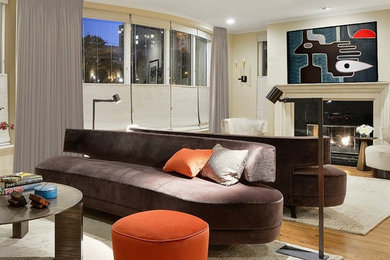 Example of a mid-sized trendy open concept light wood floor living room design with beige walls, a standard fireplace and a stone fireplace