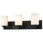 Z-Lite - Soledad Three Light Vanity, Matte Black - Let your bathroom or hallway bask in soft warm light. This contemporary three-light wall sconce has a sophisticated streamlined look and extends from a long mirrored plate for a chic contrast. From the sconce's cylindrical white etched glass shades to its matte black finish this fixture stylishly upgrades your space.