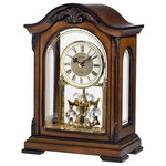 Bulova - Bulova Durant Mantel Clock - Solid wood case, Old World walnut finish. Decorative carved accents. Metal dial. Decorative screened glass front and side panels. Revolving pendulum with crystaline elements. Westminstermelody on the hour. Volume control. 2.5" x .5" engraving plate included. Requires (2) AA, (2) C batteries, not included. H: 11.5" W: 8.25" D: 5", H: 29cm W: 21cm D: 13cm