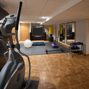 Inspiration for a small modern basement in Boston with grey walls and laminate floors.