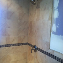 Mosaic strip on bathroom wall