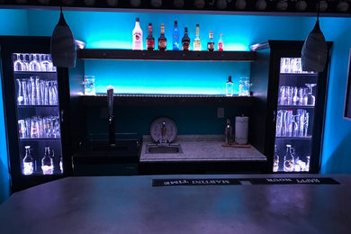 Inspiration for a mid-sized contemporary l-shaped brown floor seated home bar remodel in Other with a drop-in sink, concrete countertops and gray countertops