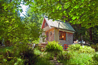 Small rustic one-story wood exterior home idea in Seattle