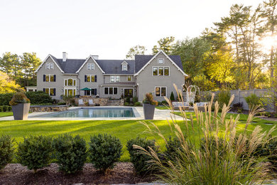 Design ideas for a traditional full sun backyard stone retaining wall landscape in Boston.