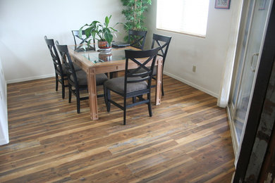 This is an example of a dining room in Phoenix with white walls and medium hardwood floors.