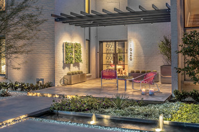 Design ideas for a small contemporary front yard full sun xeriscape for spring in Houston with a garden path and concrete pavers.