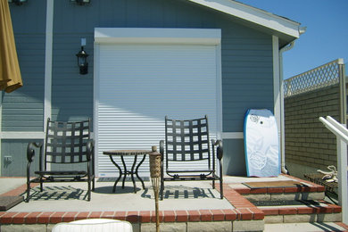 Example of a beach style backyard brick patio design in Los Angeles with no cover