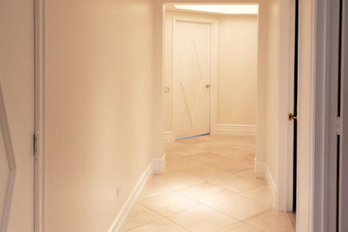 Example of a mid-sized 1960s marble floor and beige floor hallway design in Las Vegas with white walls