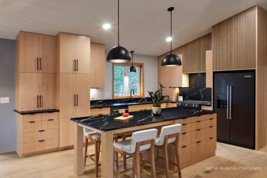 Kitchen - mid-sized modern light wood floor kitchen idea in Minneapolis with an undermount sink, flat-panel cabinets, quartz countertops, black backsplash, quartz backsplash, stainless steel appliances, an island and black countertops