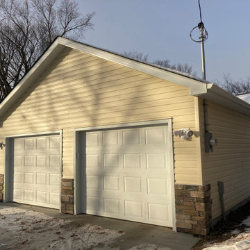 Two single car garage doors with stone detail