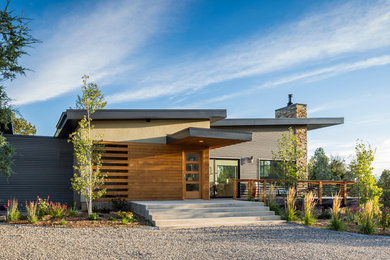 Inspiration for a mid-sized contemporary gray one-story mixed siding exterior home remodel in Albuquerque with a shed roof
