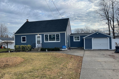 Small traditional blue two-story shingle exterior home idea in New York with a shingle roof and a black roof