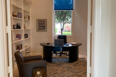 Example of a transitional home office design in Miami