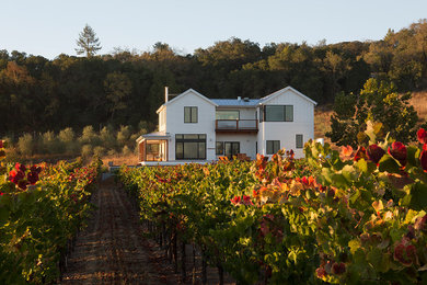 Large cottage white two-story exterior home photo in San Francisco with a hip roof