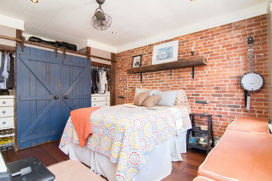 Small eclectic master medium tone wood floor bedroom photo in New York with no fireplace