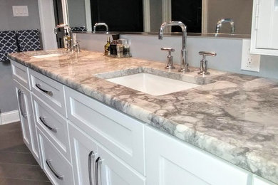 Large transitional master gray tile and slate tile ceramic tile and brown floor bathroom photo in Philadelphia with shaker cabinets, white cabinets, a one-piece toilet, gray walls, an undermount sink, granite countertops, a hinged shower door and gray countertops