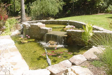 Inspiration for a mid-sized backyard partial sun garden in Birmingham with a water feature and natural stone pavers.