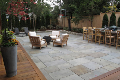 Mid-sized elegant backyard stone patio kitchen photo in Providence
