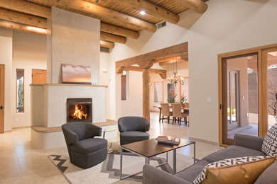 Open concept living room in Albuquerque with beige walls, a standard fireplace and beige floor.