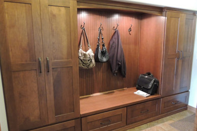 Example of a mid-sized classic travertine floor and beige floor mudroom design in Other with white walls