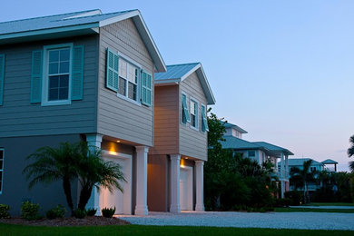 Photo of a beach style beige exterior in Tampa with concrete fiberboard siding.