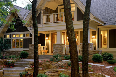 Inspiration for a huge timeless brown two-story stone exterior home remodel in Minneapolis with a shingle roof and a gray roof