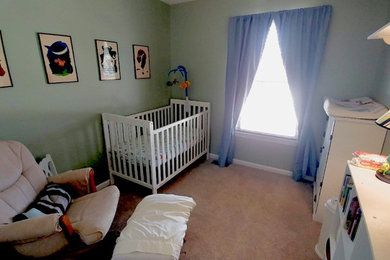 Mid-sized nursery in Detroit with green walls, carpet and beige floor for boys.