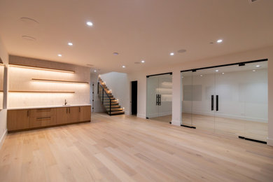 Inspiration for a large contemporary light wood floor multiuse home gym remodel in San Francisco with white walls