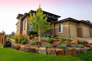 Photo of a mid-sized rustic front yard retaining wall landscape in Edmonton.