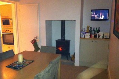 Photo of a medium sized traditional open plan dining room in Devon with white walls and a wood burning stove.
