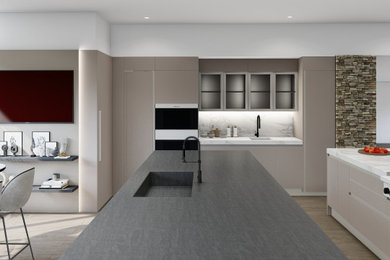 Mid-sized minimalist u-shaped eat-in kitchen photo in Phoenix with a drop-in sink, flat-panel cabinets, beige cabinets, quartz countertops, paneled appliances and two islands