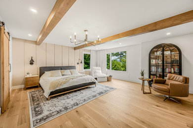 Example of a huge country master light wood floor and beige floor bedroom design in Montreal with beige walls and no fireplace