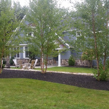 An extensive landscape project with stonewalls, patio, dry river bed & more