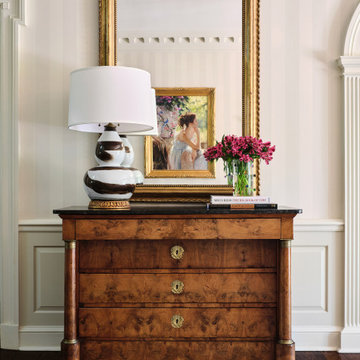 Wallpapered entry foyer in a European-inspired traditional home