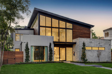 Example of a minimalist two-story mixed siding house exterior design in Houston with a shed roof