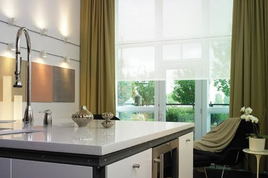 Eat-in kitchen - contemporary l-shaped dark wood floor and black floor eat-in kitchen idea in Las Vegas with an undermount sink, flat-panel cabinets, white cabinets, quartz countertops, stainless steel appliances and an island