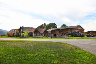 Mountain style multicolored wood exterior home photo in Other