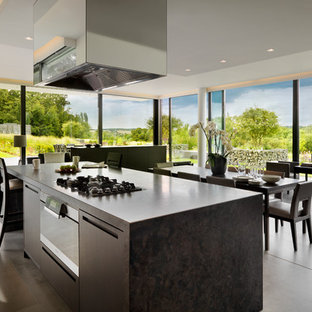 Inspiration for a modern open plan kitchen in London with flat-panel cabinets.