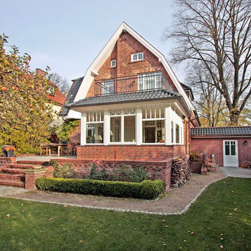 Wintergartenanbau an stilvolles Rotklinker-Wohnhaus