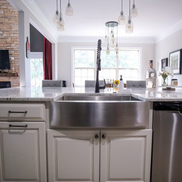 Stainless Framhouse Sink with Industrial-Style Faucet and Pendant Lighting
