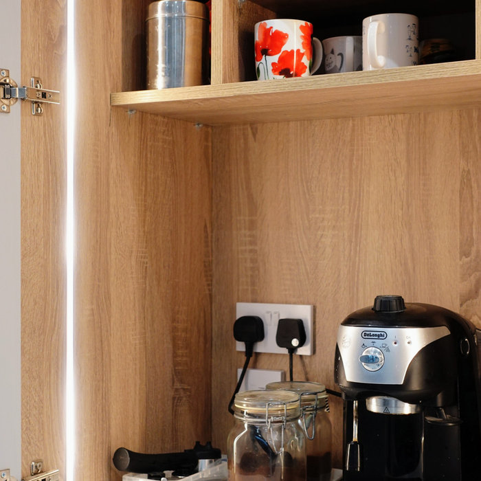 pantry, appliance garage, dresser, larder, lighting, kitchen design in Other with a drop-in sink, shaker cabinets, medium tone wood cabinets, quart