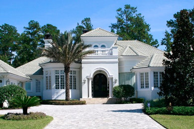 Mid-sized mediterranean white two-story stucco exterior home idea in Orlando