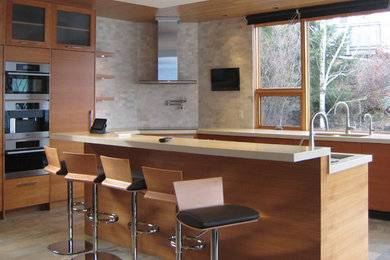 Kitchen - mid-sized contemporary l-shaped slate floor kitchen idea in Vancouver with an undermount sink, flat-panel cabinets, medium tone wood cabinets, quartzite countertops, beige backsplash, stone tile backsplash, stainless steel appliances and an island