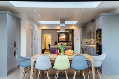 Design ideas for a contemporary kitchen/dining combo in Surrey with white walls.