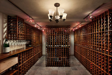 Example of a huge mountain style slate floor wine cellar design in New York