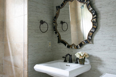 Inspiration for a small transitional stone tile travertine floor and wallpaper powder room remodel in Atlanta with a pedestal sink