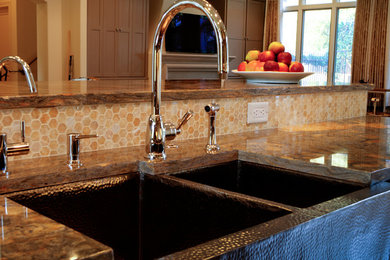 Kitchen - mid-sized transitional l-shaped slate floor kitchen idea in Austin with a farmhouse sink, shaker cabinets, dark wood cabinets, granite countertops, beige backsplash, stone tile backsplash, stainless steel appliances and an island
