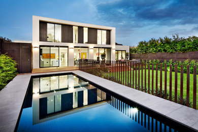 This is an example of a contemporary two-storey glass white exterior in Melbourne with a flat roof.