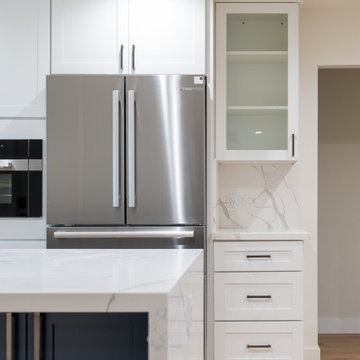 Modern White Shaker Kitchen with Navy Blue Island and Waterfall Quartz Counterto